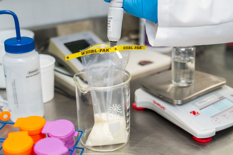 Diluting-a-milk-sample-from-a-whirl-pak-bag-close-up-horizontal-1