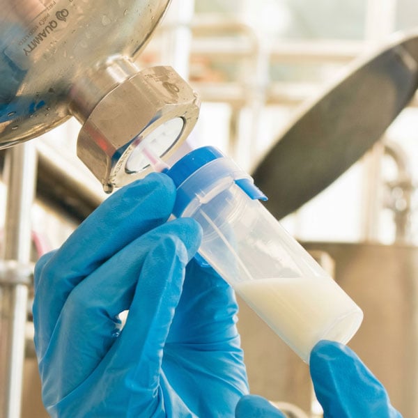 Using a QualiTru TruDraw sterile needle for aseptic sample collection in food processing.
