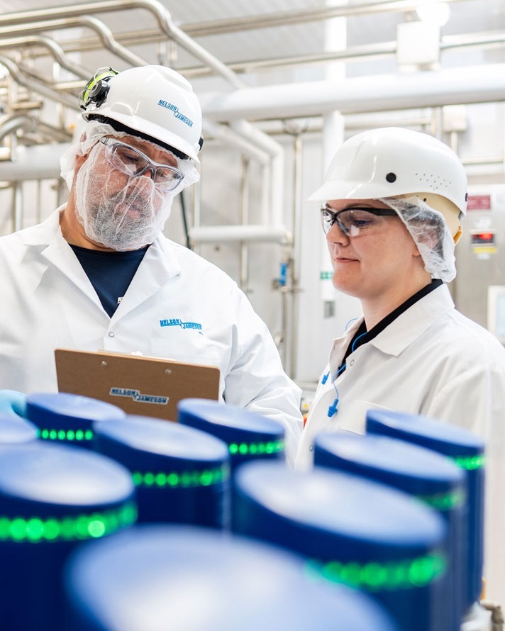 Nelson-Jameson-employee-and-customer-discussing-service-on-an-Alfa-Laval-ThinkTop-Valve-with-clipboard-1