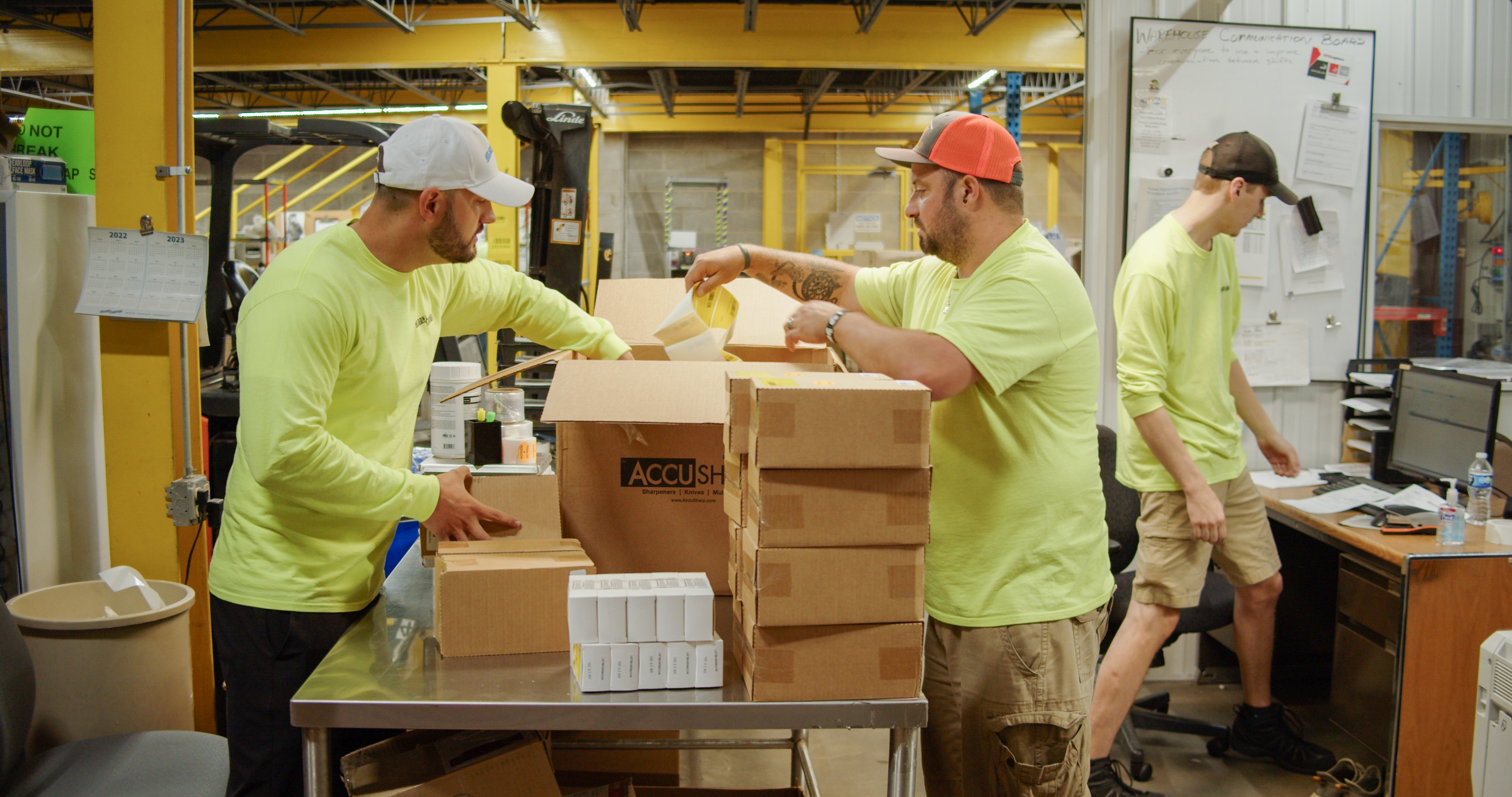 Jesse-Sojka-and-Aaron-Schalow-unpack-boxes-of-products