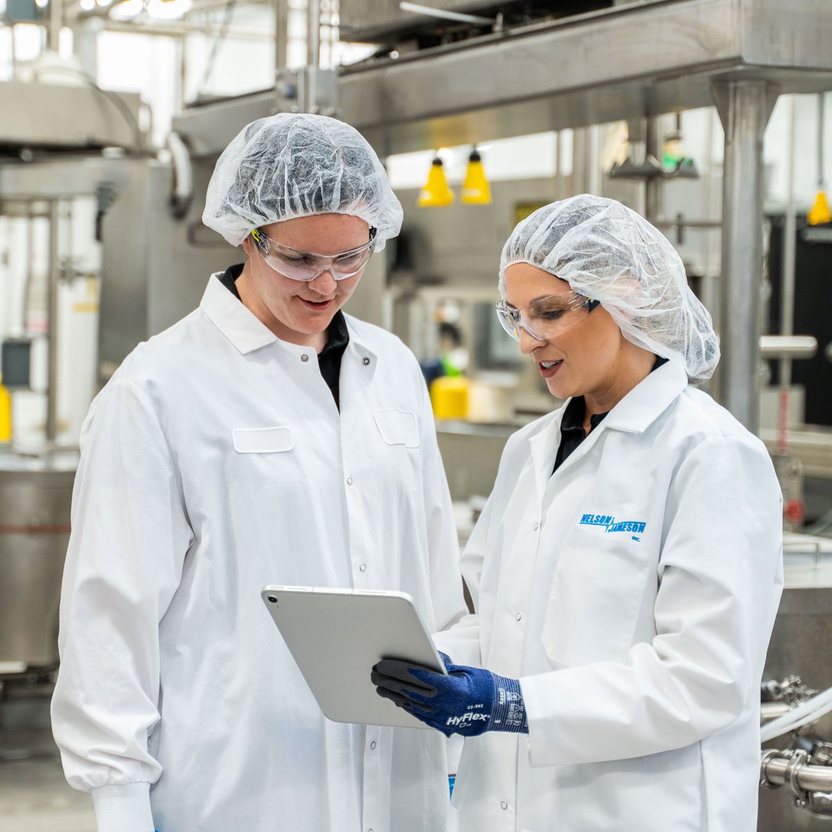 Nelson-Jameson-employee-chatting-with-customer-holding-ipad-3